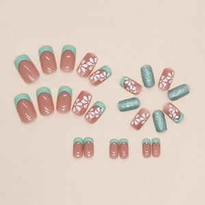 Mint green French press-on nails with white daisy floral design and glitter finish
