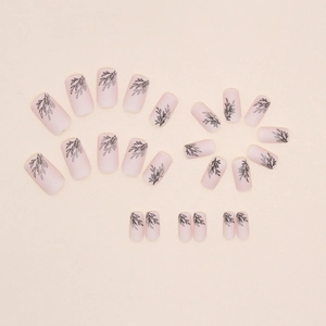 Matte nude pink square nails with black leaf silhouette patterns in a 24-piece set