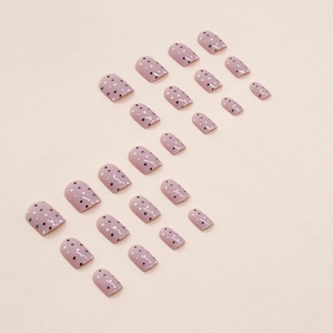 Short square pink press-on nails with black and white polka dots and glossy finish