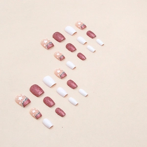 Pink and white press-on nails with leopard print, stars, and glitter finish