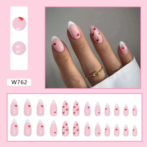 Almond press-on nails with white French tips, red hearts and gold curves nail art design
