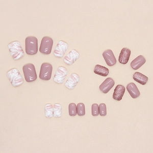 Short square pink and white press-on nails with marble ink design and glitter finish