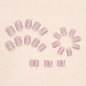 Short square frosted nude pink press-on nails with luxury gold glitter and star sequins
