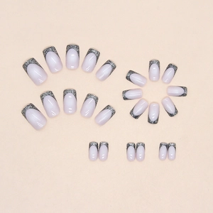 Sparkling black French press-on nails in medium-long length for a sweet and cool aesthetic