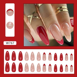 Red almond glitter press-on nails with star patterns and gradient festive design