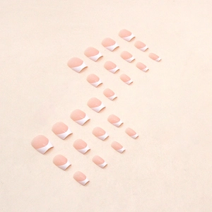 Short ballet French press-on nails with nude pink base and white tips for women