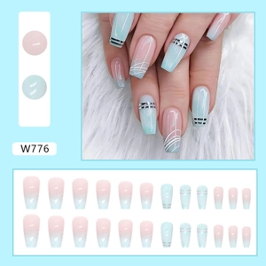Detail of gradient mint green and pink press-on nails with silver lines and leopard stars