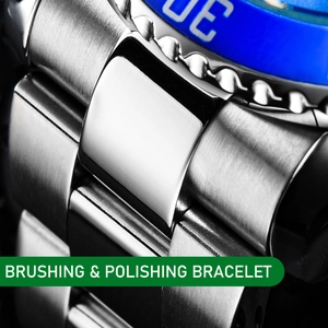 Macro detail of brushed and polished stainless steel watch bracelet with blue bezel
