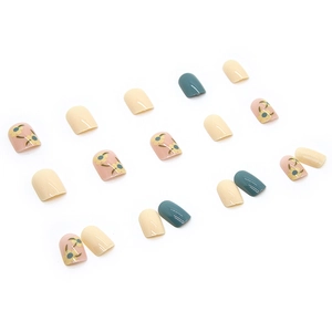 Short press-on nails with pale yellow floral patterns and Morandi blue glossy finish