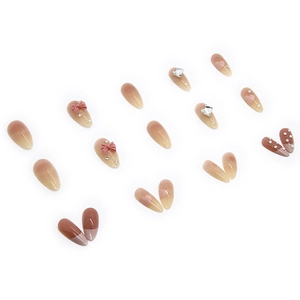 Almond shaped press-on nails with mocha gradient, 3D bows, and heart crystal accents