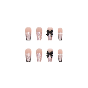 Pink French ballet style press-on nails with black 3D bows and silver glitter accents