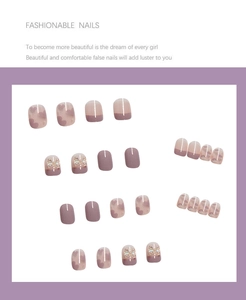Detailed view of pink press-on nails with 3D pearl bows and subtle heart patterns