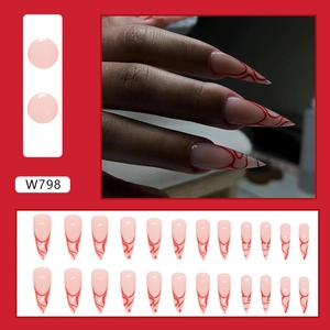 Detail view of W798 stiletto press-on nails with red wave patterns and a nude base