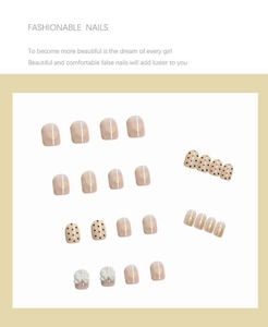Detailed close-up of 24 press-on nails with bow designs and heart patterns