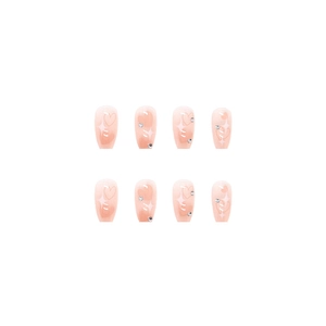 Pink gradient heart press-on nails with stars and rhinestones on white background