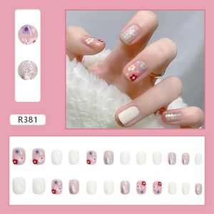 Short square press-on nails set with colorful floral designs and silver glitter accents