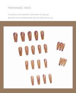 Detail of long coffin press-on nails with orange base, purple swirls, and crystal rhinestones
