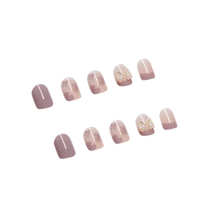 Pink press-on nails with 3D butterfly and heart art on a clean white background