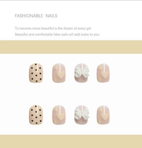Detail of sweet bow-knot press-on nail set featuring heart patterns and polka dots designs