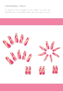 Detail of long coffin press-on nails with pink and orange cow print glossy finish