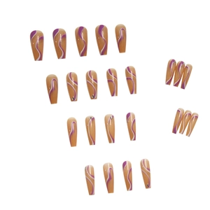 Long ballerina press-on nails with nude base and purple wavy lines and rhinestones
