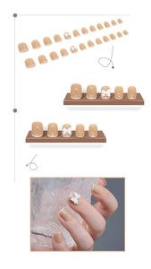 Vue détaillée des faux ongles nude avec French manucure blanche et nœuds en 3D