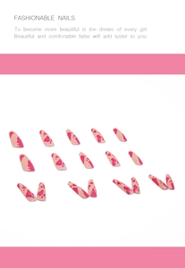 Detail of pink cow print long stiletto press-on nails with a high-gloss finish