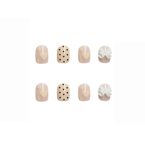 Pink and white press-on nails with 3D bows, heart patterns, and dot designs