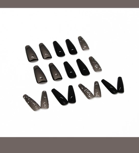 Detail of long coffin press on nails featuring black, translucent grey, and white glitter splash