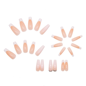 Long French press on nails in nude pink with white tips and small rhinestone accents
