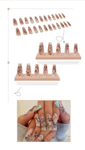 Detail view of long coffin press-on nails with blue abstract face art and gold accents