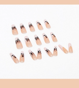 Detailed view of long ballerina press-on nails featuring French tips and black butterfly art