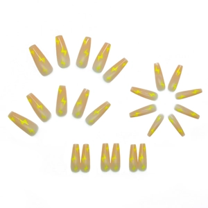 Long coffin press on nails in nude pink featuring vibrant yellow lightning bolt designs
