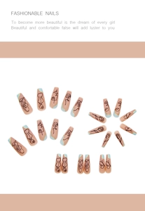 Macro shot of long coffin fake nails with line art portraits and blue gold accents