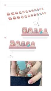Detail of cute handmade press-on nails with cartoon bunny and heart patterns