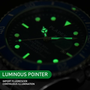 Macro detail of the green luminous dial and hands on the PLADEN quartz watch in the dark