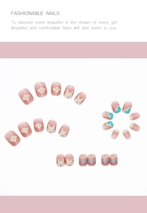 Close-up of pink gradient press-on nails featuring hand-painted rabbit and cloud patterns