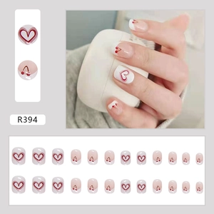 Short round press-on nails with red heart and cherry patterns in 24-piece full set