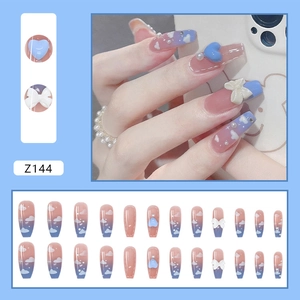 Detail view of 24pcs blue gradient press-on nails with 3D hearts, bows and pearls