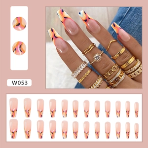 Detail view of long ballet press-on nails with orange flame patterns and 24pc set layout
