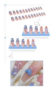 Detail view of blue gradient press-on nails with 3D hearts, bows and pearls