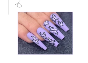 Detailed view of matte lavender coffin press on nails featuring black butterfly nail art
