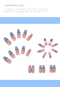 Detail of long coffin nails with blue gradient clouds, pearls, and bow charms