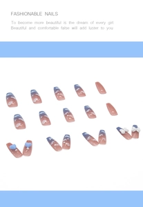 Detail of coffin press-on nails with 3D blue hearts, bows, and starry sky design