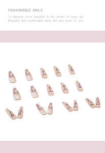Detail of artistic nude pink press-on nails with abstract black line art and gold glitter