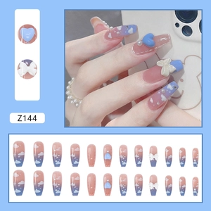 Blue gradient press-on nails with 3D heart, bow accents, and starry cloud patterns