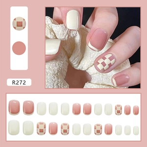 Short square pink checkerboard press-on nails set shown on hand and laid out