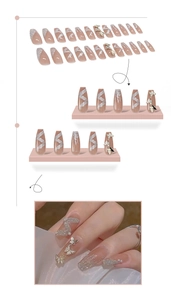 Detail of long ballerina press-on nails with pink glitter and gold butterfly charms