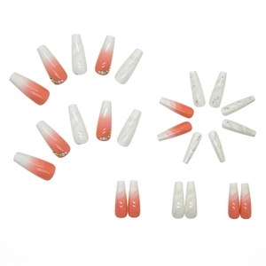 White gradient press-on nails set with rhinestones and marble patterns in long coffin shape