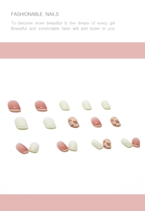 Detail of pink checkerboard press-on nails with French tip design in multiple sizes